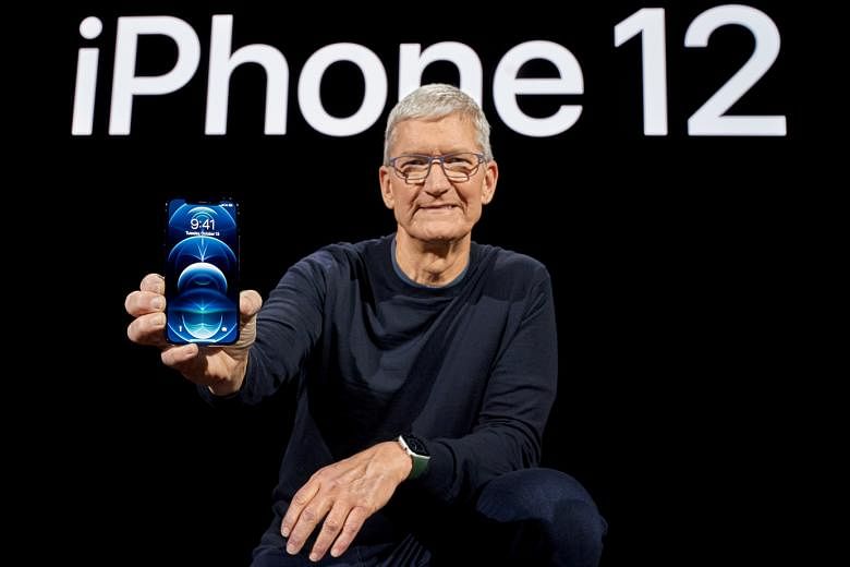 Apple chief executive Tim Cook with one of the brand's new 5G smartphones, the iPhone 12 Pro.