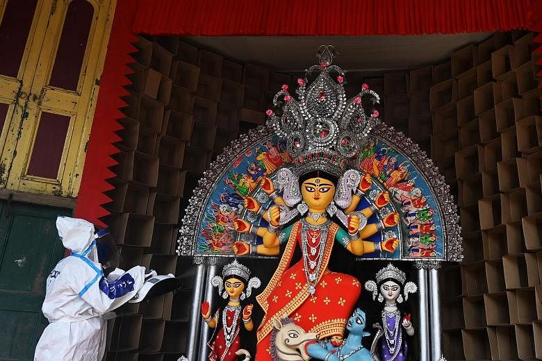 An idol of the Hindu goddess Durga being sanitised in Kolkata on Tuesday ahead of the upcoming Durga Puja festival.