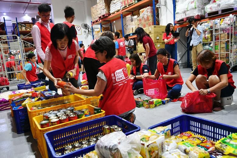 Volunteers helping to pack food at Food from the Heart in February. Deputy Prime Minister Heng Swee Keat praised ground-up community movements founded to help those in need, and encouraged those who could to continue donating generously during this p