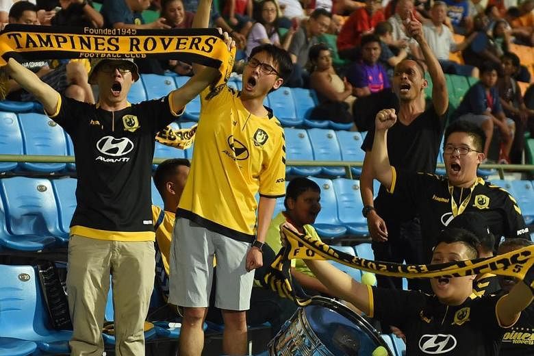 Tampines fan Pang Jia Tai (right, wearing glasses) at an AFC Cup game last year. He is looking forward to the SPL's return. PHOTO COURTESY OF TAMPINES ROVERS