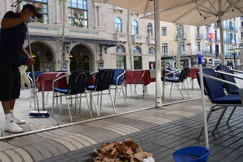 The outdoor seating area of a restaurant in the Spanish city of Barcelona where bars and restaurants have been ordered closed for 15 days from yesterday to curb a surge in coronavirus cases. The International Monetary Fund projects a partial and unev