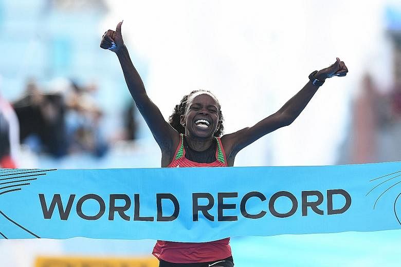 Kenyan Peres Jepchirchir is delighted as she crosses the finishing line in a world record time of 1:05:16.
