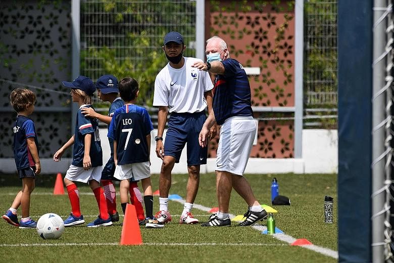 French Football Academy Singapore technical director Patrick Vallee gesturing during a training session at the Gems World Academy yesterday.