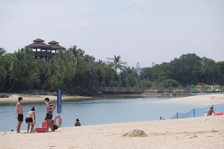 At Palawan Beach yesterday, guests were issued wristbands for admission after they presented their confirmation e-mail for verification. Beachgoers yesterday at Palawan Beach on Sentosa had plenty of space to themselves, with the roll-out of an onlin