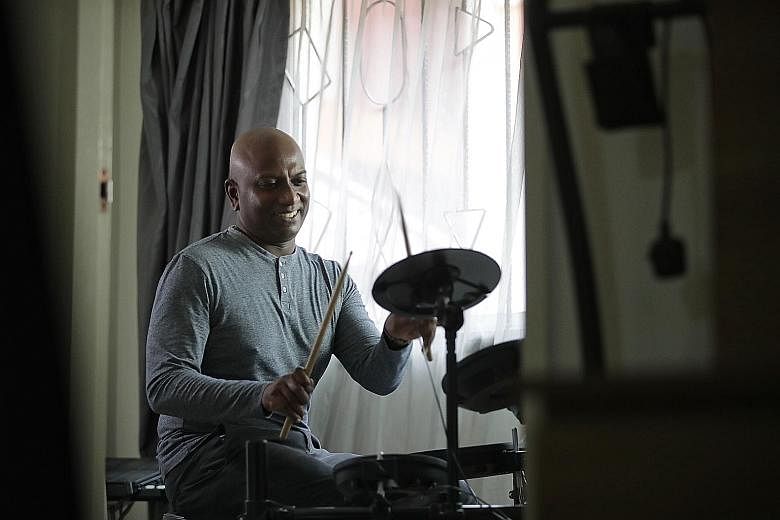 Music educator Vicknes Vinayak Veerappan, 46, drumming in his Bishan home studio last Wednesday. In 2017, he decided to first take up a diploma in law as a foundation for his subsequent degree. It gave him insight into copyright and intellectual prop