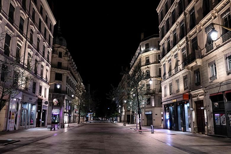 A deserted street in Lyon, France, last Saturday, after a month-long night-time curfew was put in place in nine cities in the country. Those venturing outside risk a fine unless they can show good reason to be out and about. PHOTO: AGENCE FRANCE-PRES
