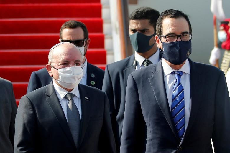 Israeli National Security Adviser Meir Ben-Shabbat (left) and US Treasury Secretary Steve Mnuchin arriving in Bahrain, yesterday. Bahrain followed the United Arab Emirates in agreeing to normalise ties with Israel.