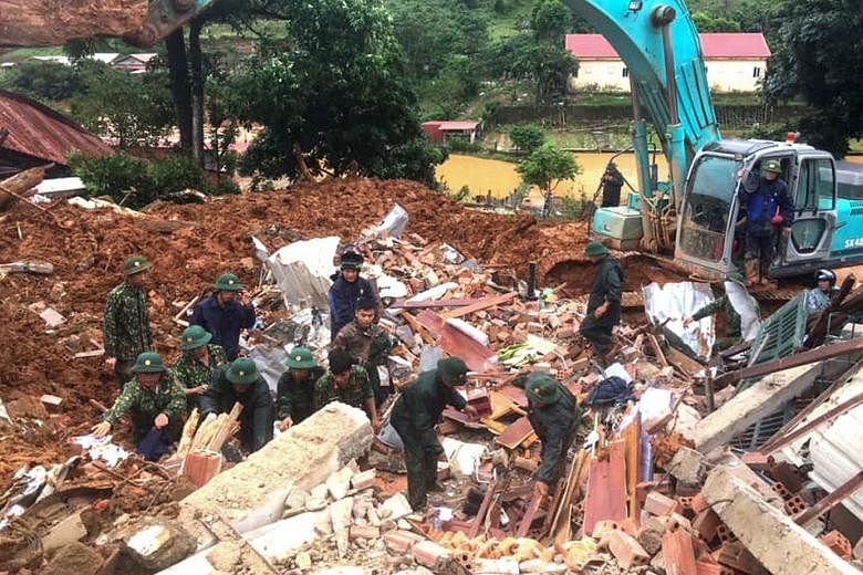 Vietnamese military staff searching for missing soldiers after a mudslide hit the barracks of a unit of the country's 4th Military Region in the central province of Quang Tri yesterday. The disaster management authority has warned of further flooding