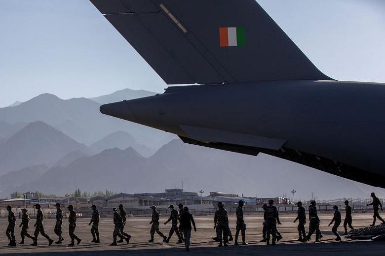 Indian soldiers disembarking from a military transport plane at a forward airbase in Leh, in the Ladakh region, last month.