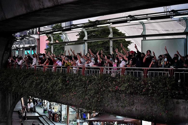 Pro-democracy protesters outside the Victory Monument BTS skytrain station in Bangkok yesterday.