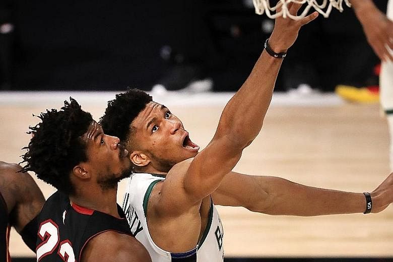 Milwaukee Bucks' Giannis Antetokounmpo driving past Jimmy Butler of the Miami Heat during their NBA Eastern Conference play-off series in August. Both teams are among the contenders next season.