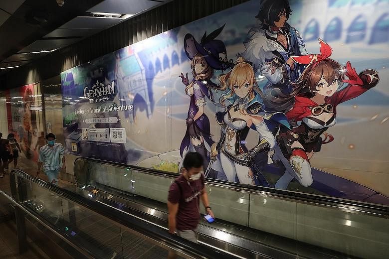 A massive advertisement for the free-to-play mobile game Genshin Impact at Serangoon MRT station. Concerns are mounting that such games, which feature gambling-like elements, commonly called loot boxes, are gaining mainstream prominence here. ST PHOT
