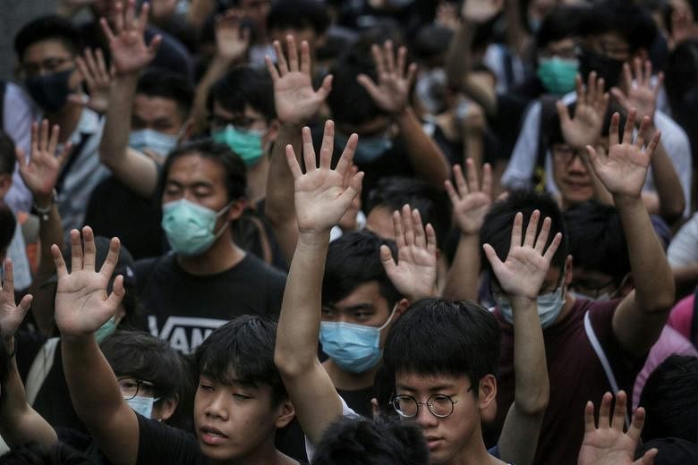 Demonstrators in Hong Kong in September last year holding up their hands to symbolise the five demands of the protests. Hand symbols are also popular in the Thai protests, where people use a three-finger salute.