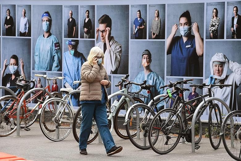 A photo display put up to thank healthcare workers outside the Royal Melbourne Hospital in Melbourne, Victoria's capital. Just three new Covid-19 cases were reported in the Australian state yesterday, a dramatic turnaround from early August, when the