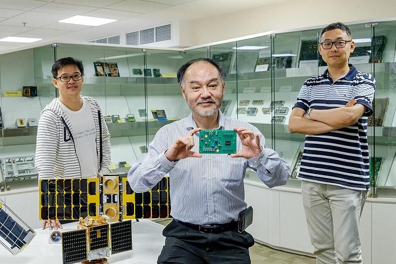 Professor Joseph Chang (centre) of Nanyang Technological University holding the Latchup Detection and Protection chip launched by Zero-Error Systems (ZES). With him are Dr Chong Kwen Siong (left), ZES co-founder, and Dr Shu Wei, ZES chief technology 
