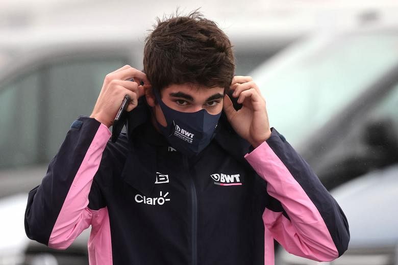 Racing Point driver Lance Stroll putting on a face mask during the Eifel Grand Prix in Nurburgring. He withdrew a day before the Oct 11 race.