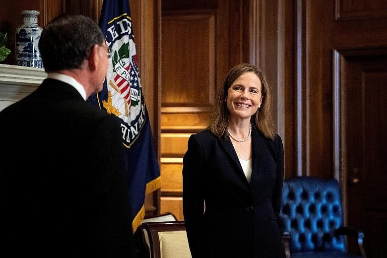With Republicans holding a Senate majority, Ms Amy Coney Barrett - seen here with Senator John Barrasso of Wyoming on Wednesday - appears certain to be confirmed for the US Supreme Court next Monday.