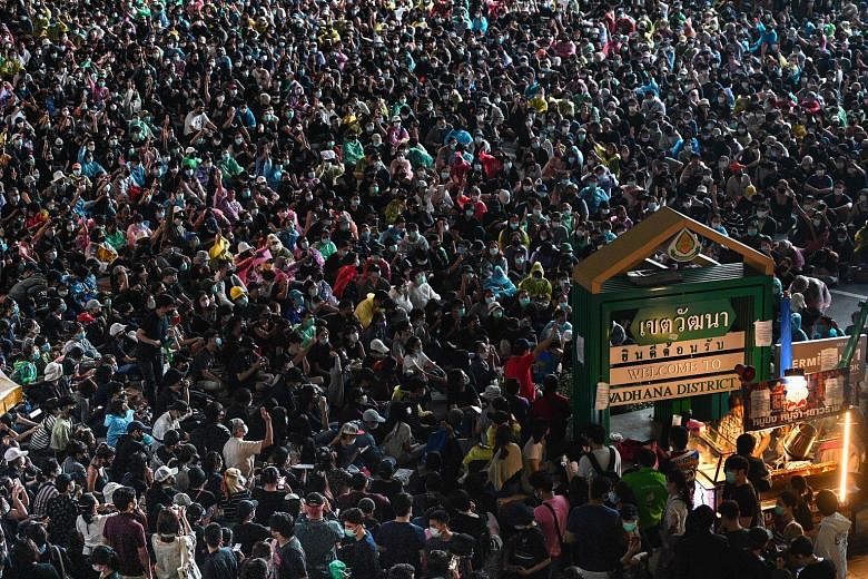 Above and right: Supporters of the monarchy at a rally opposing the student-led pro-democracy movement in Bangkok yesterday. Such rallies in support of King Maha Vajiralongkorn have raised fears of clashes between the rival groups. The emergency decr