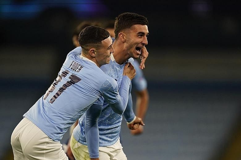 Ferran Torres celebrating with Phil Foden after sealing City's 3-1 win over Porto in Wednesday's Champions League game at the Etihad Stadium. PHOTO: REUTERS