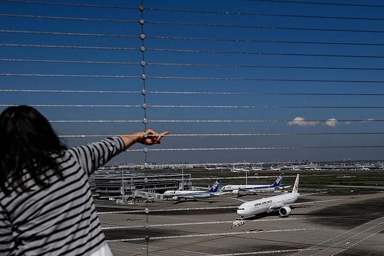 A view from the observation deck at Tokyo's Haneda airport early this month. Under the latest plan, the Japanese government is planning to relax curbs for business travellers from 30 nations and regions.