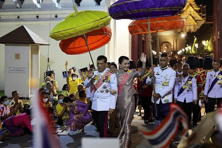 Thailand's King Maha Vajiralongkorn and Queen Suthida greeting royalists at the Grand Palace in Bangkok yesterday. PHOTO: REUTERS