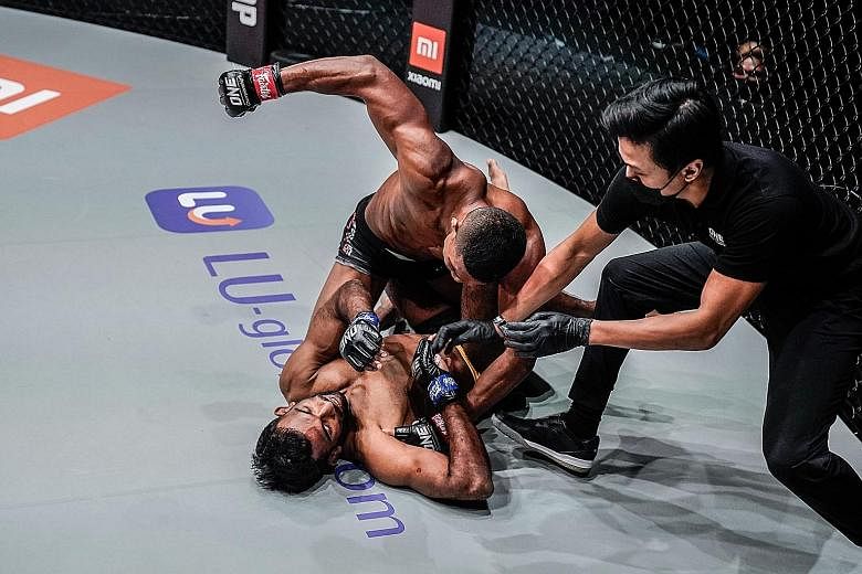 Singaporean fighter Amir Khan (top) taking on India's Rahul Raju at One Championship's Reign of Dynasties closed-door event at the Singapore Indoor Stadium on Oct 9. For next Friday's Inside the Matrix event, fans will need to take an antigen rapid t