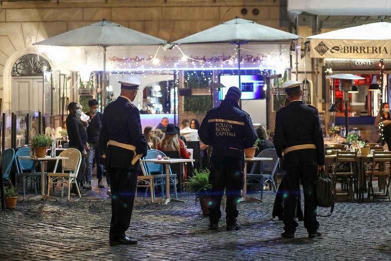 Italian police patrolling outside restaurants in Rome on Thursday. Italy and other European countries such as Austria, Croatia, Slovenia and Bosnia reported their highest single-day increases of Covid-19 cases on Thursday.