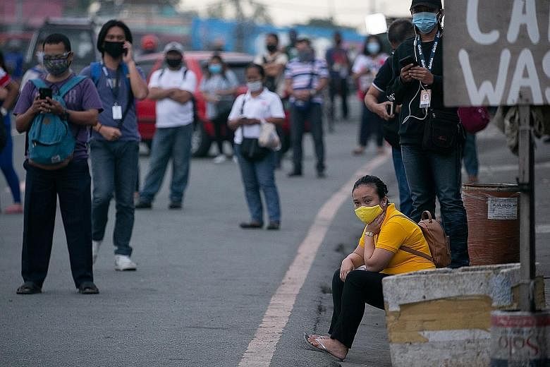 Stranded workers waiting for shuttle services after the suspension of mass transportation during a lockdown in the Philippines in August. With millions out of work, the government and the private sector must work together more closely to address the 