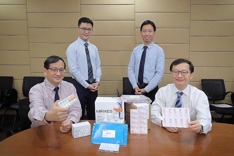 From left: NUS Yong Loo Lin School of Medicine's Associate Professor Too Heng-Phon, MiRXES co-founder and CEO Zhou Lihan, NUH's Division of Gastroenterology and Hepatology consultant Calvin Koh and NUH's Professor Jimmy So with the gastric cancer tes