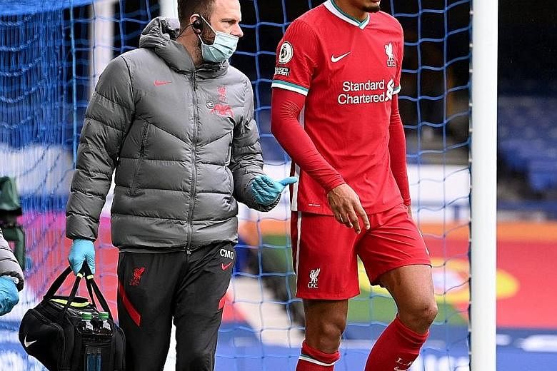 Liverpool's Virgil van Dijk limping off after his injury on Oct 17. He suffered a complete tear of his ACL after Everton goalkeeper Jordan Pickford's tackle in the 2-2 English Premier League draw.