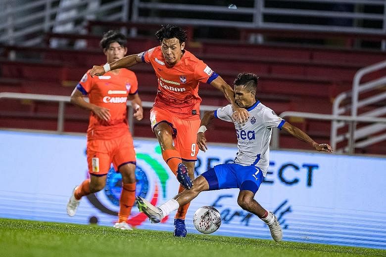 Lion City Sailors midfielder Aqhari Abdullah tackling Albirex Niigata forward Reo Nishiguchi in yesterday's SPL match at Jurong East Stadium. The White Swans' winner came amid controversy, as their opponents claimed there was a handball in the build-