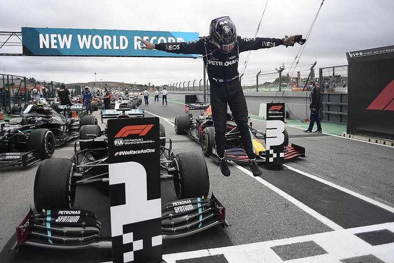 Lewis Hamilton celebrating his win at Portugal's Algarve International Circuit yesterday. He took the chequered flag with a massive 25.6-second lead.