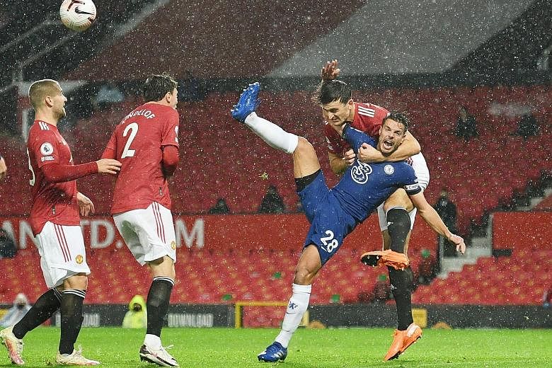 Manchester United captain Harry Maguire hauling Chelsea defender Cesar Azpilicueta to the ground in the first half. The VAR checked the incident and found there was no clear and obvious error. PHOTO: REUTERS