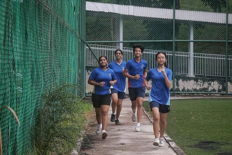 From far left: Ping Yi Secondary students Ravi Raveena, 15, Nadia Sharon Moh Omar, 15, Dexter Lee, 15, and Tan Yee Yean, 16, at their school field last Friday. ST PHOTO: KEVIN LIM