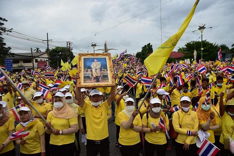 A royalist supporter with a portrait of Thailand's King Maha Vajiralongkorn in a mass rally to show support for the Thai royal establishment in Narathiwat province in southern Thailand yesterday. PHOTO: AGENCE FRANCE-PRESSE