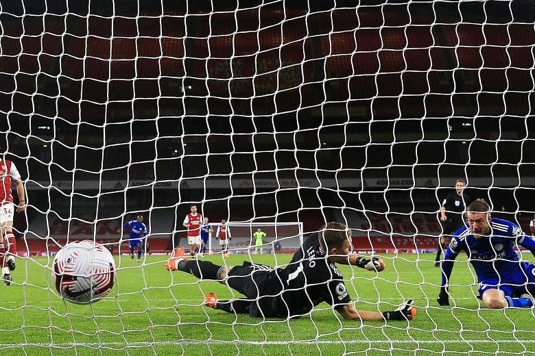 Leicester striker Jamie Vardy scoring past Arsenal goalkeeper Bernd Leno in the 1-0 Premier League victory in London on Sunday. The Foxes are now fourth in the standings. PHOTO: EPA-EFE
