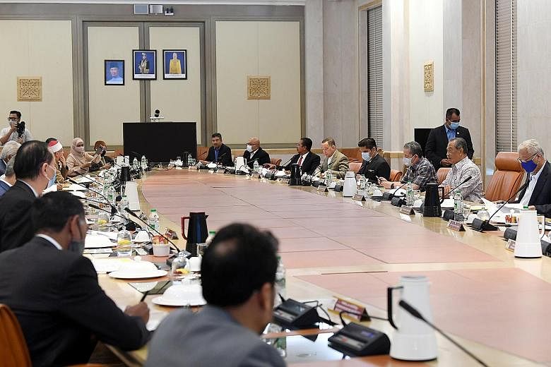 Malaysian Prime Minister Muhyiddin Yassin (right) chairing a National Security Council meeting on Covid-19 earlier this month. The Premier early yesterday met party chiefs from his Perikatan Nasional coalition, but a notable absentee was Umno preside