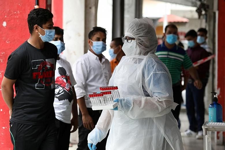 A medical worker preparing to administer coronavirus swab tests outside a clinic in Kajang, Selangor, yesterday. Malaysia saw 1,240 Covid-19 cases yesterday, with seven new fatalities, bringing the total to 27,805 cases with 236 deaths. PHOTO: REUTER