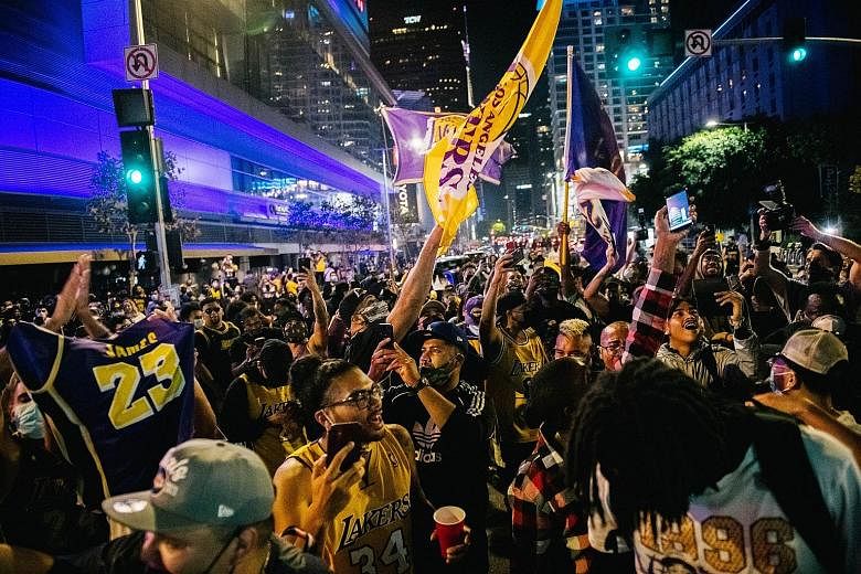 Lakers fans, breaking health regulations, gathering in front of the Staples Centre to celebrate the team's 17th NBA championship.