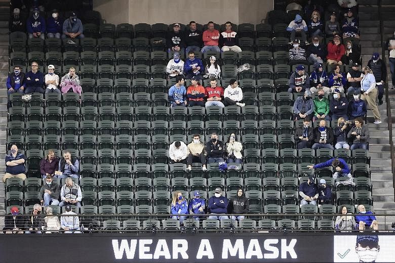 Groups of fans are separated for social distancing at Game 4 of the Tampa Bay-LA Dodgers World Series at Globe Life Field in Arlington, Texas last Saturday. While signs encouraged them to wear masks, many chose not to do so.