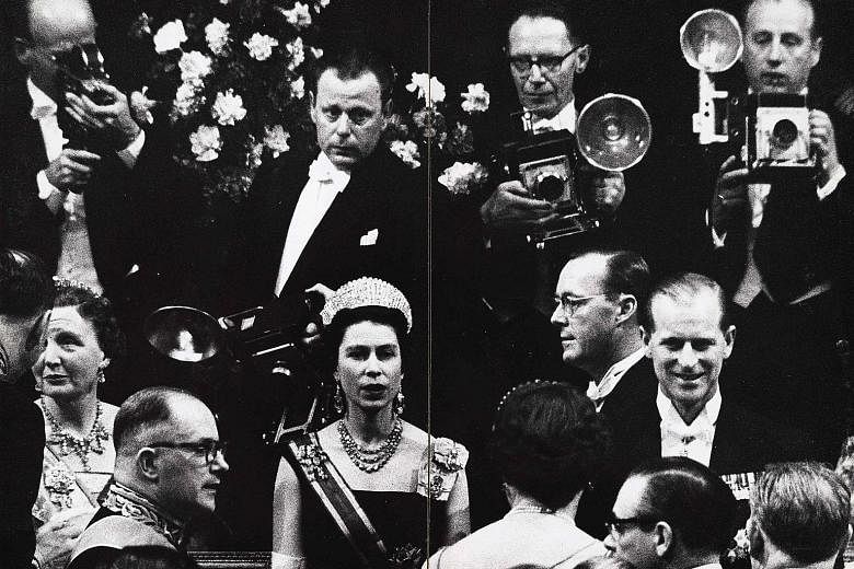 A picture taken in 1958 by Dutch photographer Ed van der Elsken of British regent Queen Elizabeth II (front row, centre) and her husband Prince Philip (left) in The Hague, with Dutch Queen Juliana and her husband Prince Bernard.