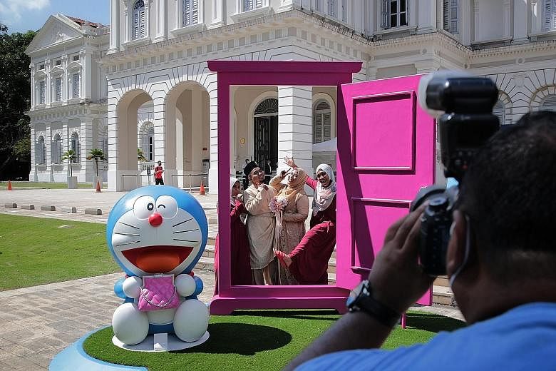 Doraemon figures as well as an Anywhere Door (main picture) on the front lawn of the National Museum of Singapore. (Above) The Doraemon installation has been curated with highlights of the museum's collections from the 1960s through to the 1980s.