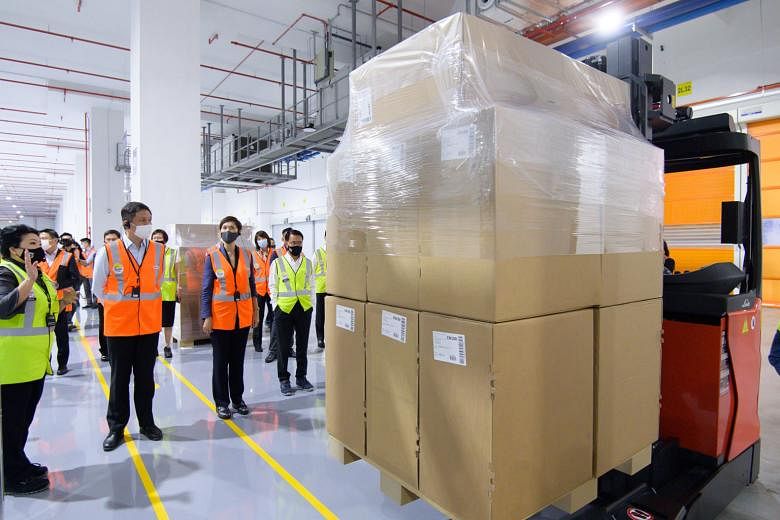 Trade and Industry Minister Chan Chun Sing and Manpower Minister Josephine Teo at German logistics firm DB Schenker's Red Lion facility in Changi yesterday. Mr Chan says Singapore's reliability as a logistics hub has become much more important during