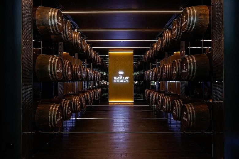 The Macallan Experience at Raffles Hotel Singapore features a tunnel lined with oak casks (above) and a bar and lounge (left) where guests can sample a variety of drams from the distillery.
