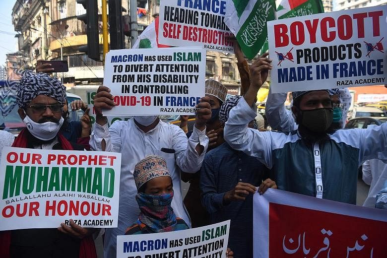 Muslim demonstrators taking to the streets in Mumbai yesterday to call for a boycott of French products and denounce French President Emmanuel Macron over his comments.