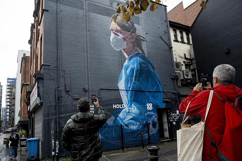 A mural depicting National Health Service nurse Melanie Senior in Manchester's Northern Quarter. Britain is swamped by a second wave of Covid-19 infections that could pose an even bigger test than the first wave for its overextended health service.