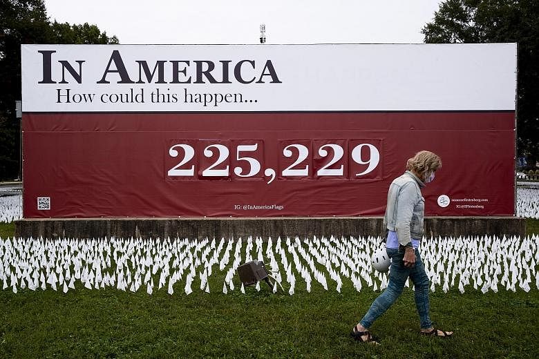 A memorial at the D.C. Armory parade ground in Washington, DC on Tuesday, with a sign showing a recent figure representing the number of people in the United States who had died of Covid-19. The disease has killed more than 226,000 people in the US s