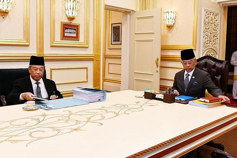 Malaysia's Prime Minister Muhyiddin Yassin (left) and the country's King, Sultan Abdullah Ahmad Shah, at their meeting at the National Palace in Kuala Lumpur yesterday. The Premier briefed the King on the crucial supply Bill that will be tabled in Pa