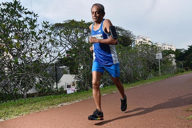 Chandrasekaran near the Old Bukit Timah Railway Station yesterday, when he completed the 175km ST Virtual Run distance. He covered the distance over 16 sessions. ST PHOTO: DESMOND WEE