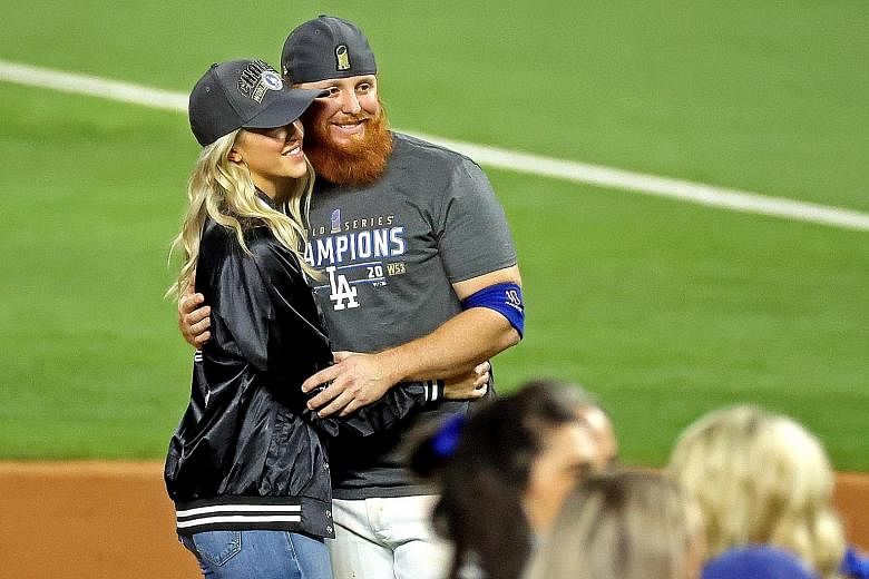 Justin Turner celebrating the LA Dodgers' World Series win with his wife Kourtney Pogue on Tuesday. Turner was back on the field after the game, having been withdrawn midway through the eighth inning after MLB learnt he had tested positive for the co